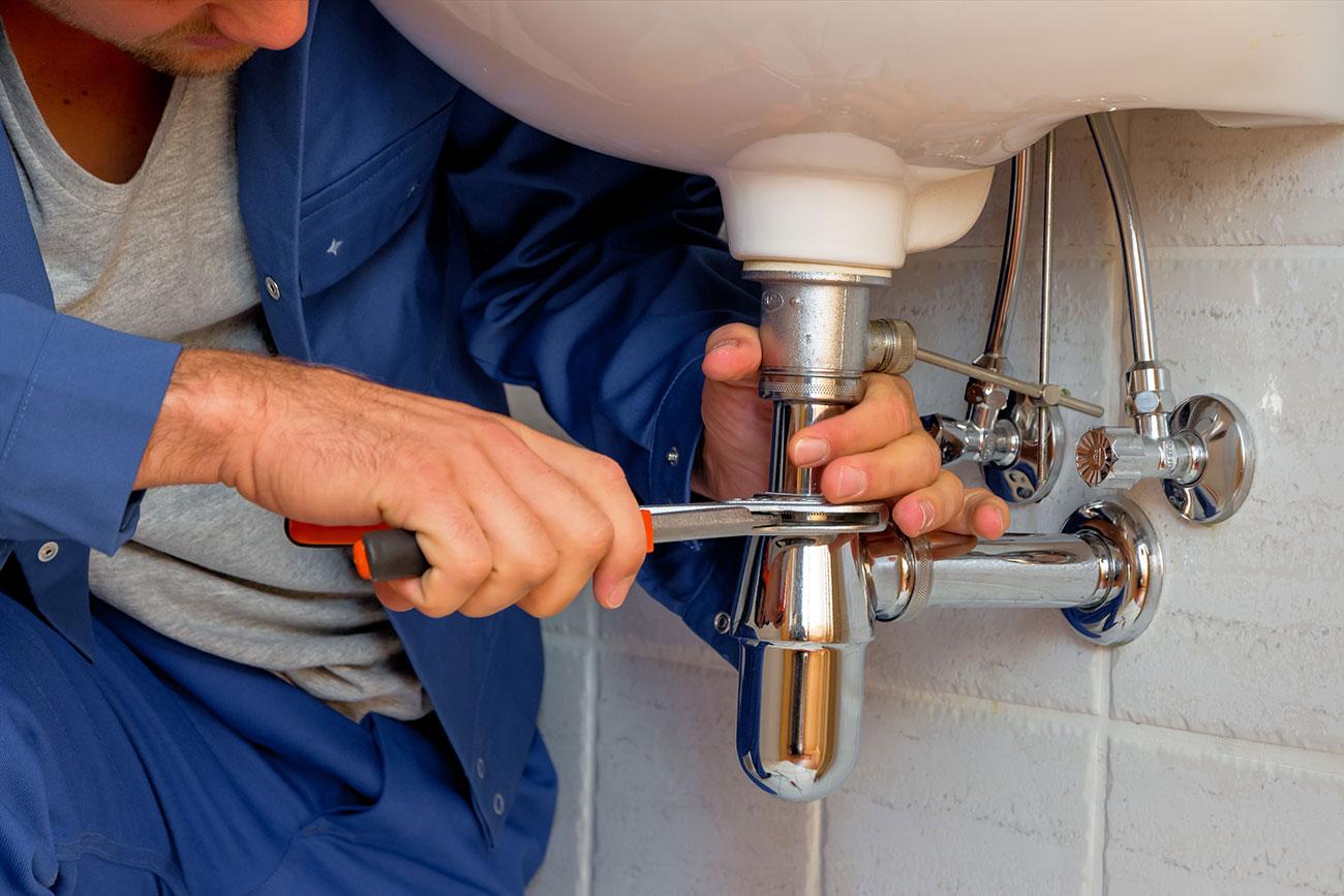 repairing piping on a kitchen sink